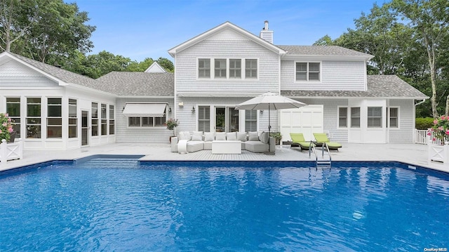 rear view of property featuring outdoor lounge area and a patio