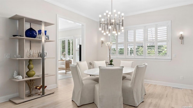 dining space with crown molding, light hardwood / wood-style floors, and a notable chandelier