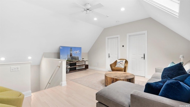 living room featuring light wood-type flooring, vaulted ceiling, and ceiling fan