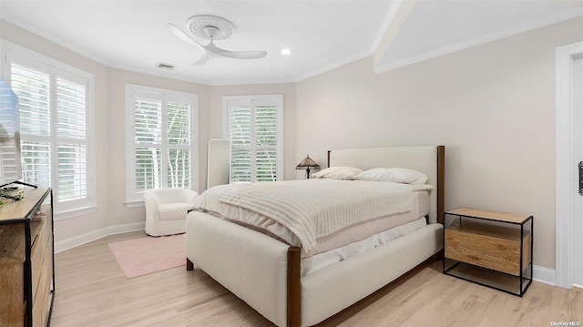 bedroom with light hardwood / wood-style flooring, ceiling fan, and ornamental molding