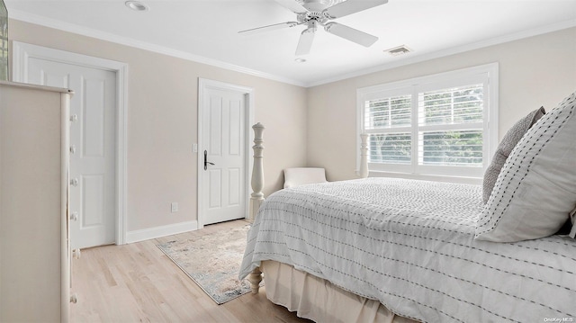 bedroom with light hardwood / wood-style floors, ceiling fan, and ornamental molding