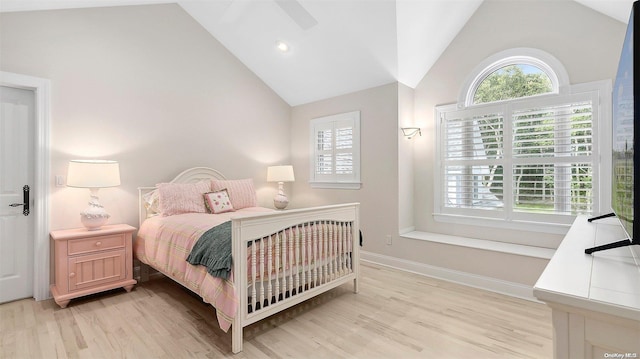 bedroom featuring light hardwood / wood-style flooring, ceiling fan, and lofted ceiling