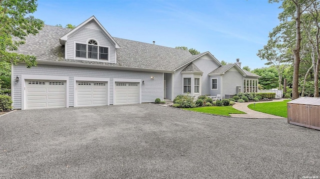 view of front of property with a front yard and a garage