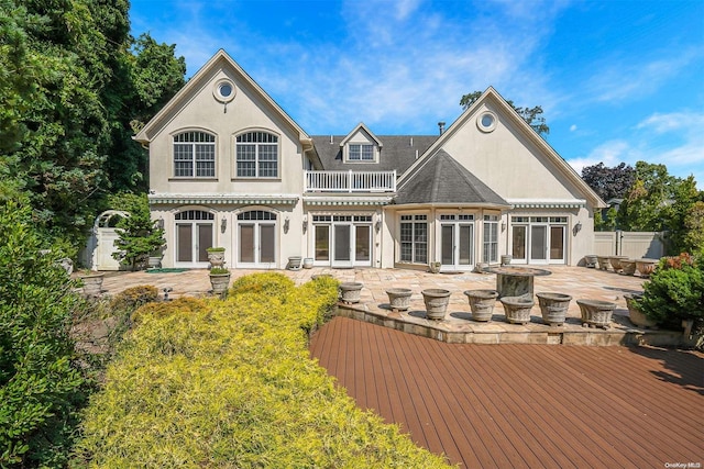 back of house with a balcony, a patio, and a wooden deck