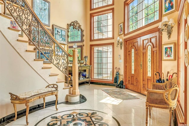 entryway featuring a towering ceiling