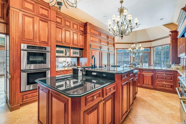 kitchen with an island with sink, decorative light fixtures, a notable chandelier, and appliances with stainless steel finishes