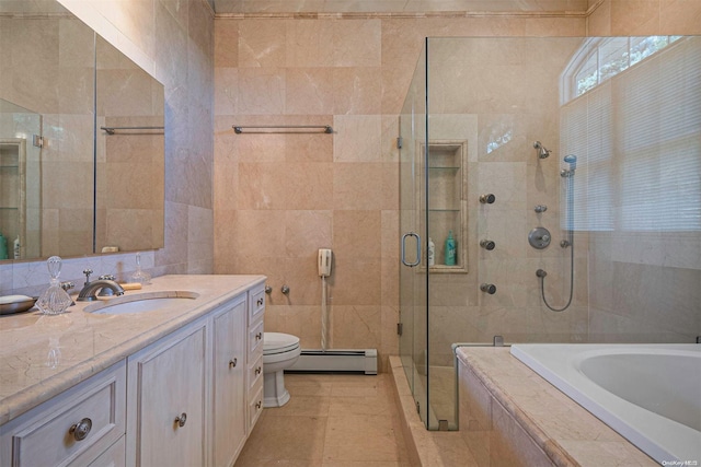 full bathroom featuring vanity, baseboard heating, tile walls, independent shower and bath, and toilet