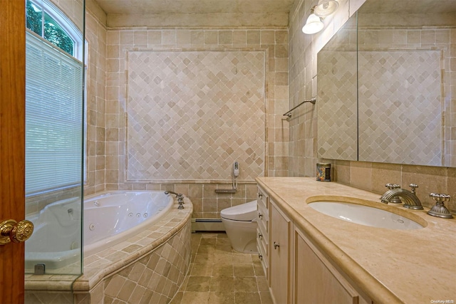 bathroom with a baseboard radiator, tiled bath, toilet, vanity, and tile walls