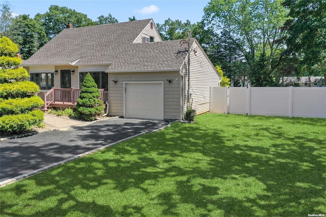 view of front of home with a front lawn and a garage