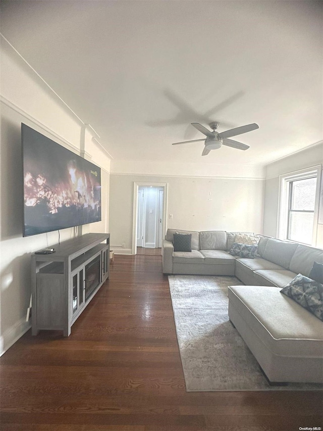 living room featuring dark hardwood / wood-style floors and ceiling fan