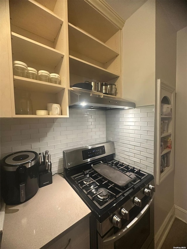 kitchen with tasteful backsplash and stainless steel range with gas stovetop