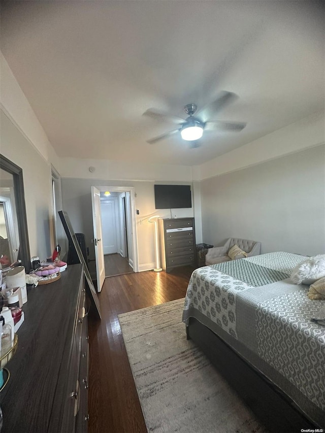 bedroom with ceiling fan and dark hardwood / wood-style flooring