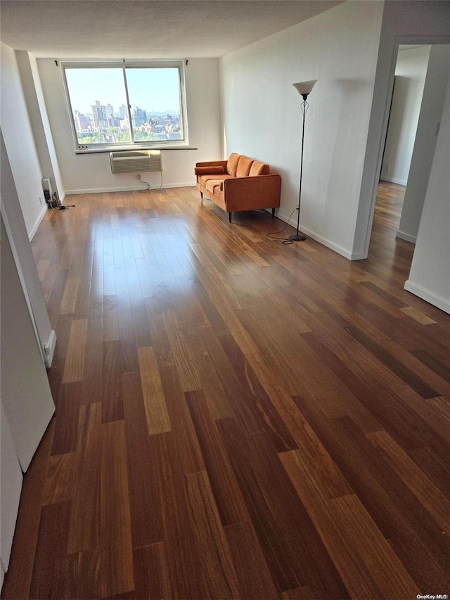 interior space featuring dark wood-type flooring and a wall mounted air conditioner