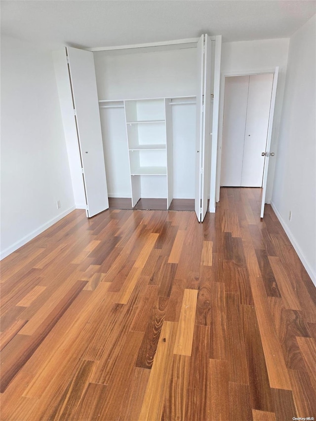 unfurnished bedroom with hardwood / wood-style floors