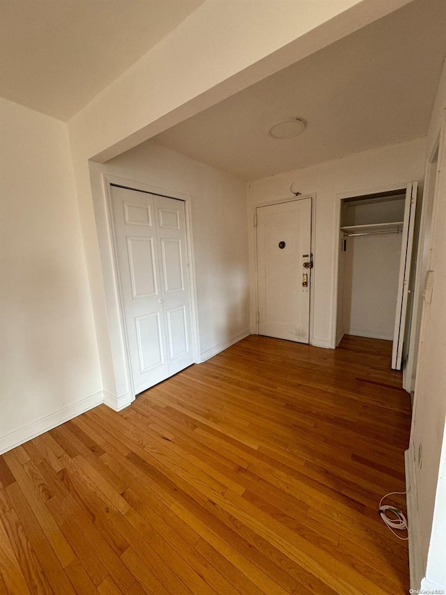 unfurnished bedroom with wood-type flooring