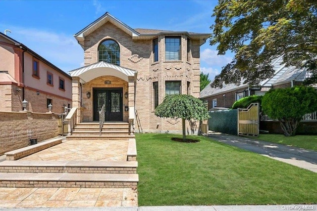 view of front of property with a front yard and french doors