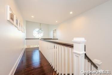 hallway with dark wood-type flooring