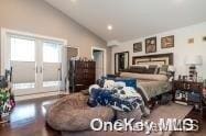 bedroom with high vaulted ceiling