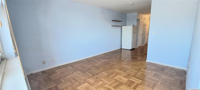 spare room featuring dark parquet floors