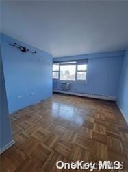 spare room with dark parquet flooring