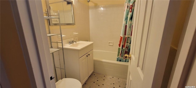 full bathroom featuring tile patterned flooring, vanity, toilet, and shower / tub combo with curtain