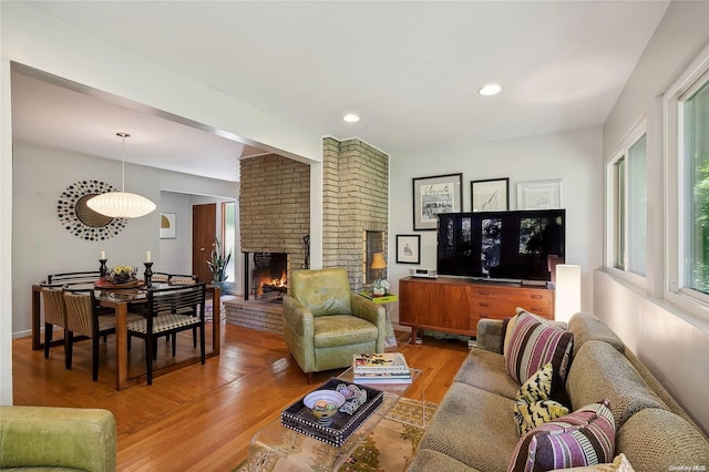 3 Pennington Dr, Huntington, NY 11743 - living room with light wood-style flooring, a brick fireplace, recessed lighting, and baseboards