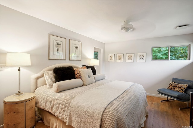 bedroom with hardwood / wood-style flooring and ceiling fan