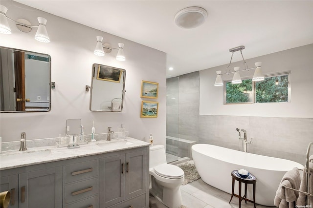 3 Pennington Dr, Huntington, NY 11743 - bathroom featuring toilet, double vanity, a freestanding bath, tile patterned floors, and a tile shower