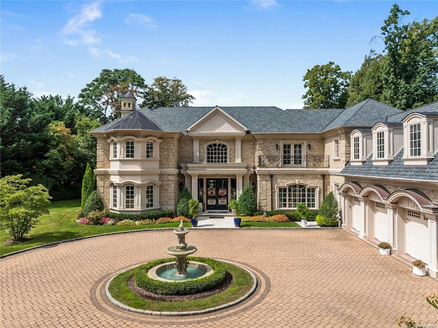 french country home with french doors and a garage