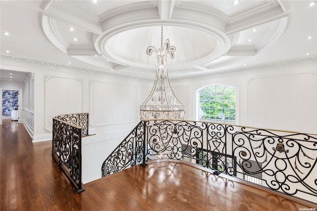 hallway featuring wood-type flooring, crown molding, and coffered ceiling