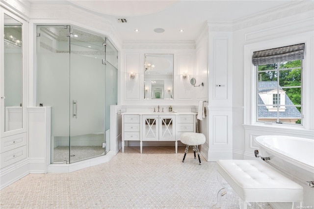 bathroom with vanity, ornamental molding, and plus walk in shower