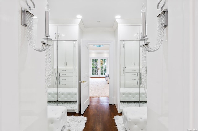 hall with dark hardwood / wood-style flooring and ornamental molding