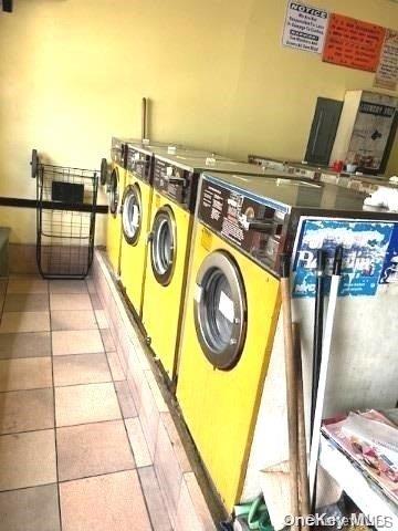 washroom featuring light tile patterned floors and separate washer and dryer