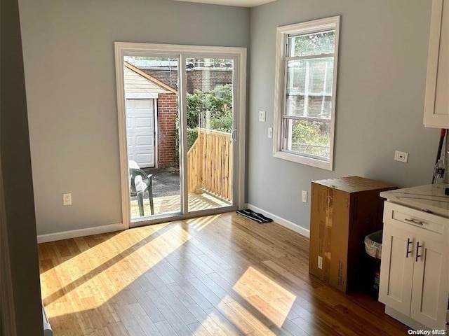 doorway with hardwood / wood-style flooring