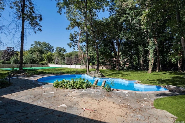 view of swimming pool with a lawn and a patio area