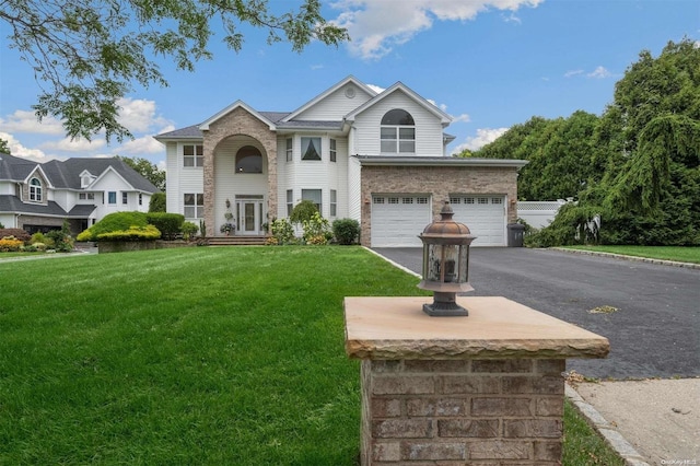 view of front of house featuring a garage and a front lawn