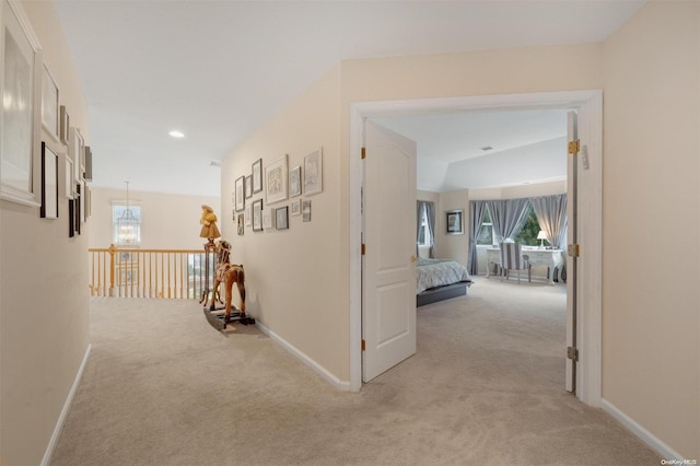 hallway featuring light colored carpet