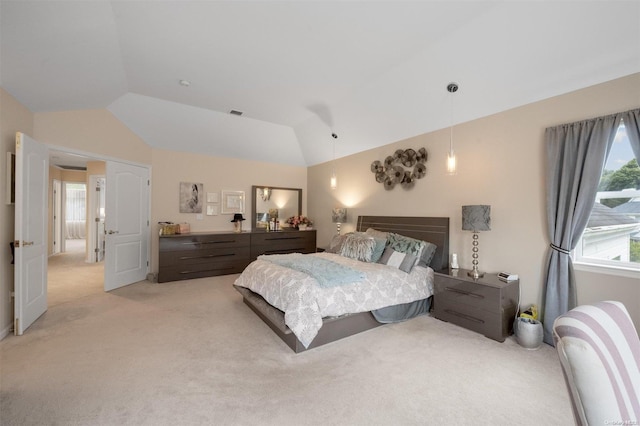 bedroom with light colored carpet and lofted ceiling