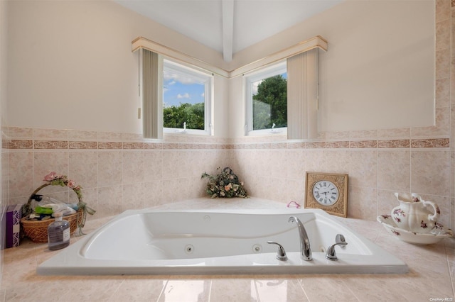 bathroom featuring tiled bath and vaulted ceiling