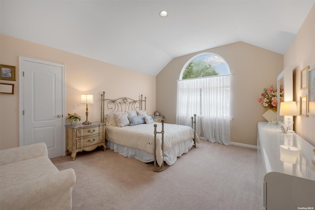 bedroom featuring light colored carpet and lofted ceiling