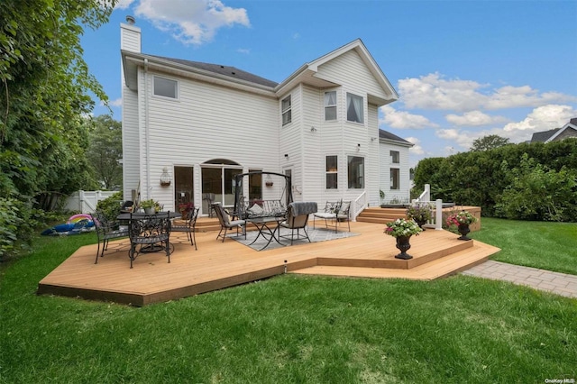 rear view of property with an outdoor hangout area, a lawn, and a wooden deck