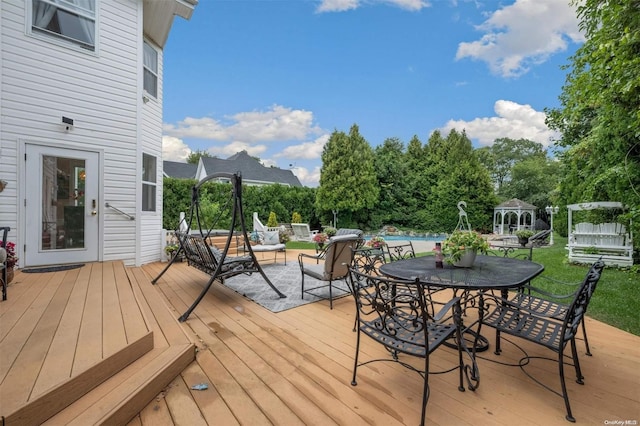 wooden terrace featuring a swimming pool