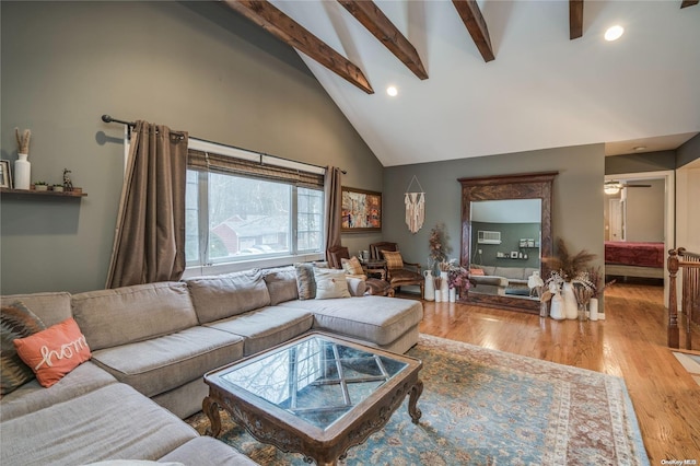 living room featuring beamed ceiling, hardwood / wood-style flooring, and high vaulted ceiling