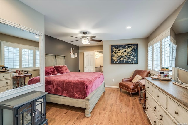 bedroom with light hardwood / wood-style floors and ceiling fan