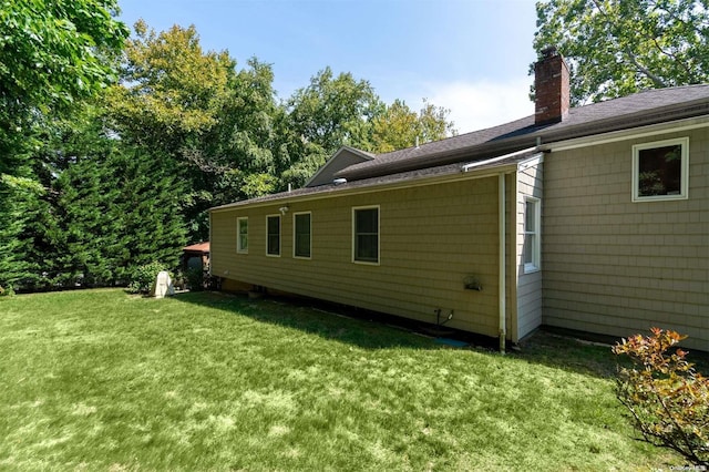 view of side of home featuring a yard