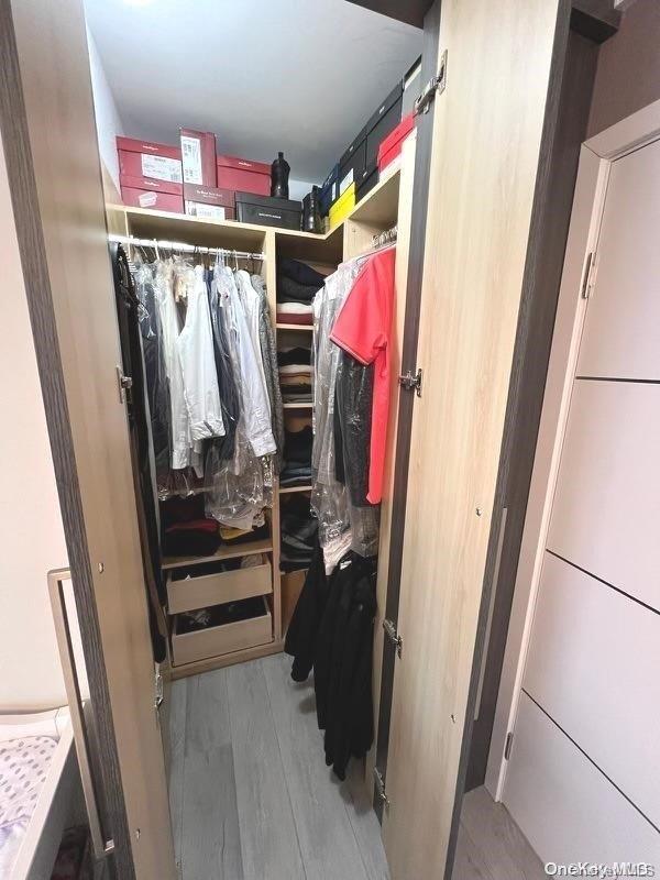 spacious closet featuring light hardwood / wood-style floors