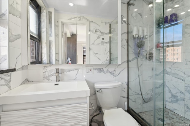 bathroom featuring vanity, crown molding, toilet, tile walls, and a shower with shower door