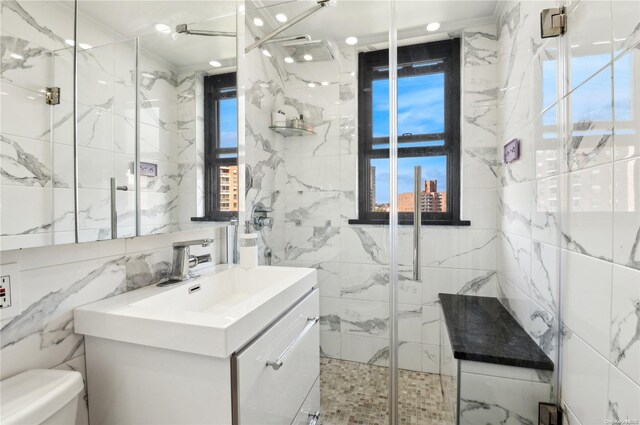 bathroom featuring a wealth of natural light, vanity, tile walls, and ornamental molding