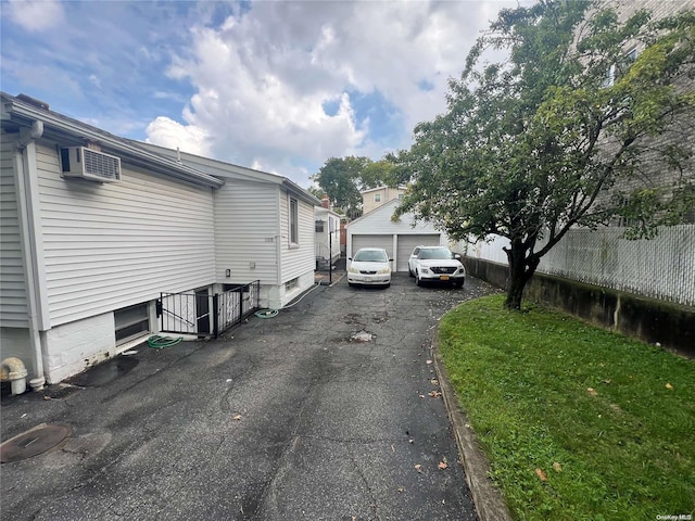 view of property exterior featuring a wall mounted air conditioner and a garage