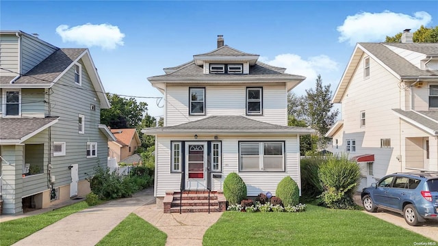 185 Utter Ave, Staten Island, NY 10314 - traditional style home featuring entry steps, a front lawn, a chimney, and roof with shingles